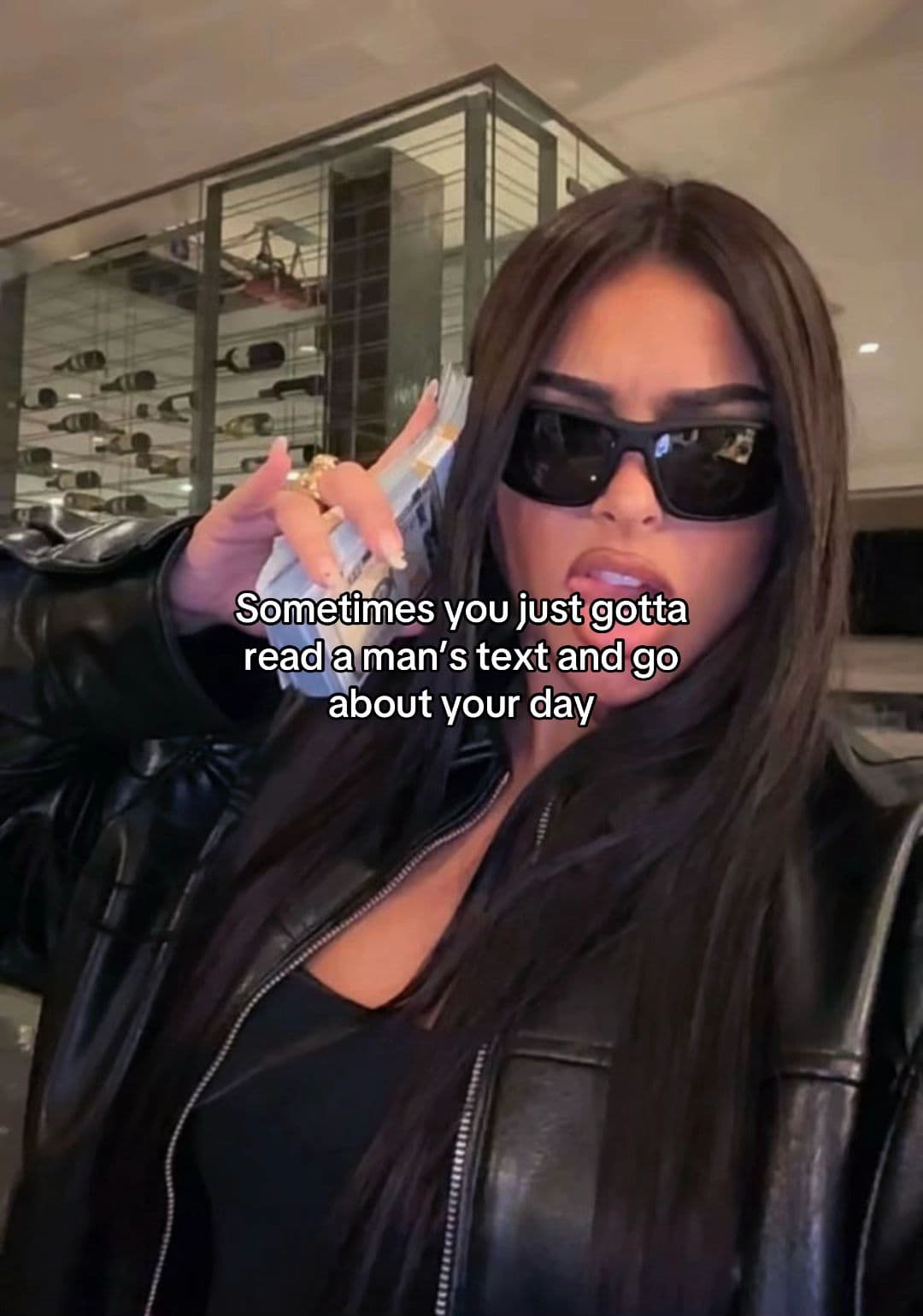 A woman in sunglasses holding cash with the text Sometimes you just gotta read a man’s text and go about your day.