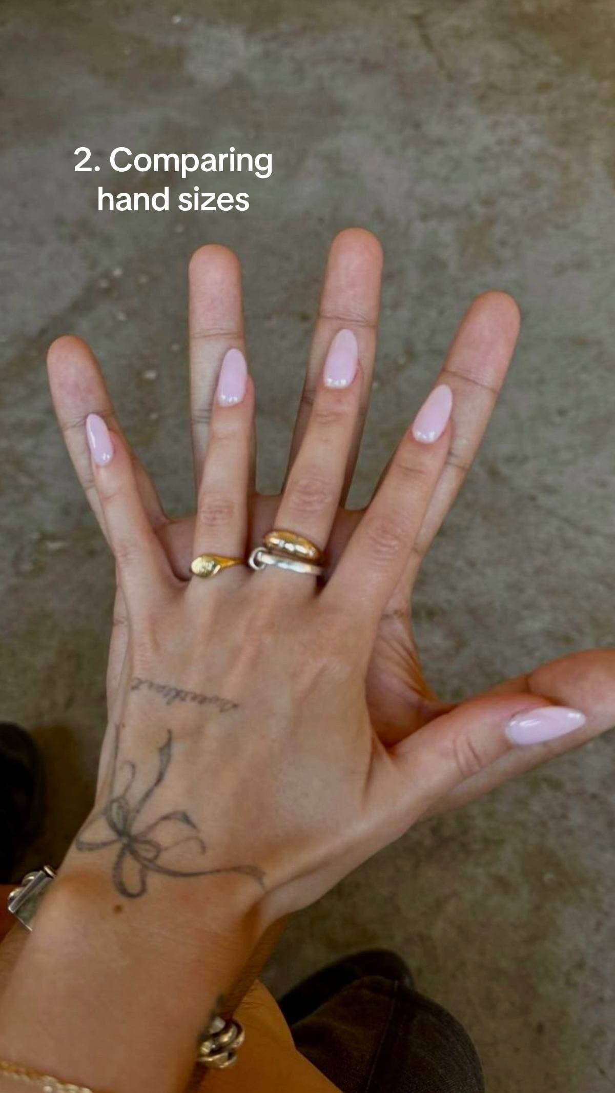 Two overlapping open hands with the overlay comparing hand sizes.