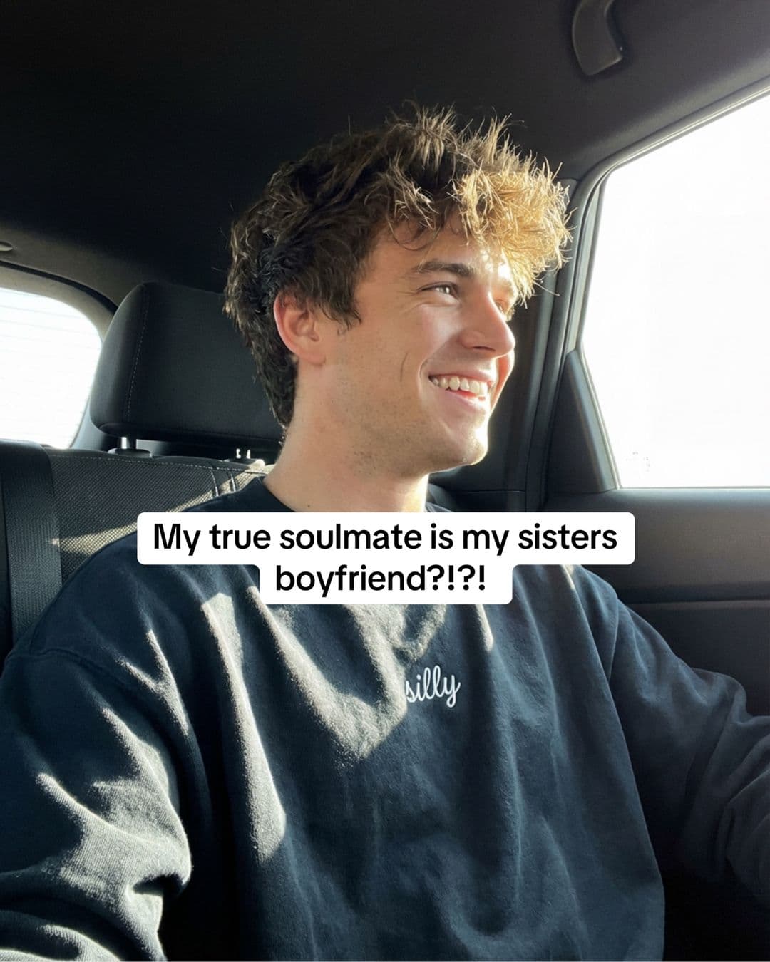 Young man sitting in a car with text identifying him as the creator's sister's boyfriend