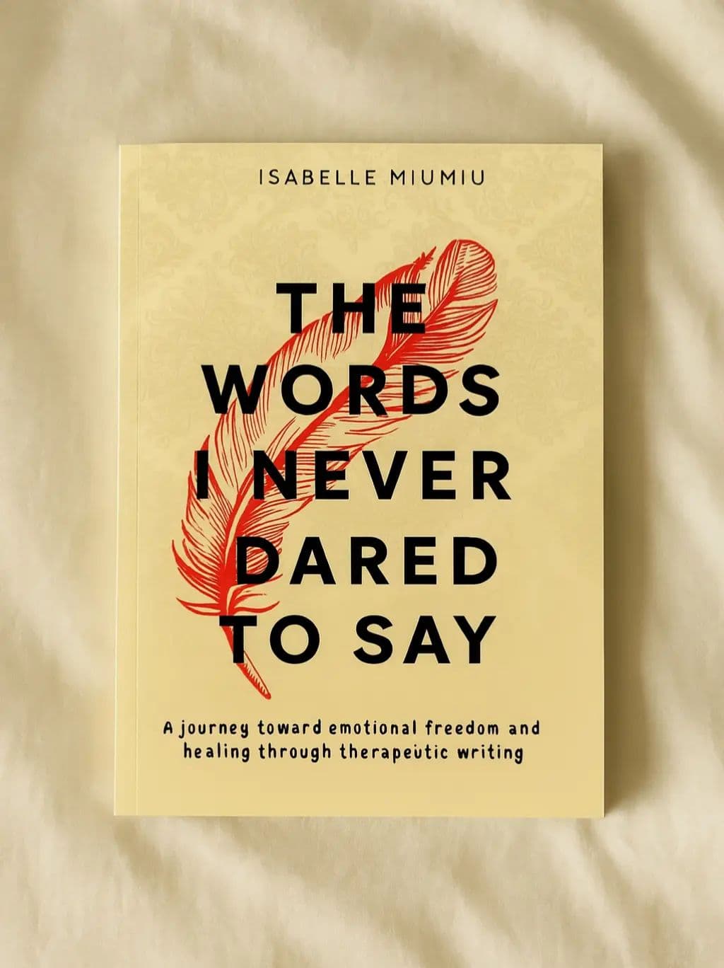 Slide three: The Words I Never Dared to Say book cover photographed on pale fabric.